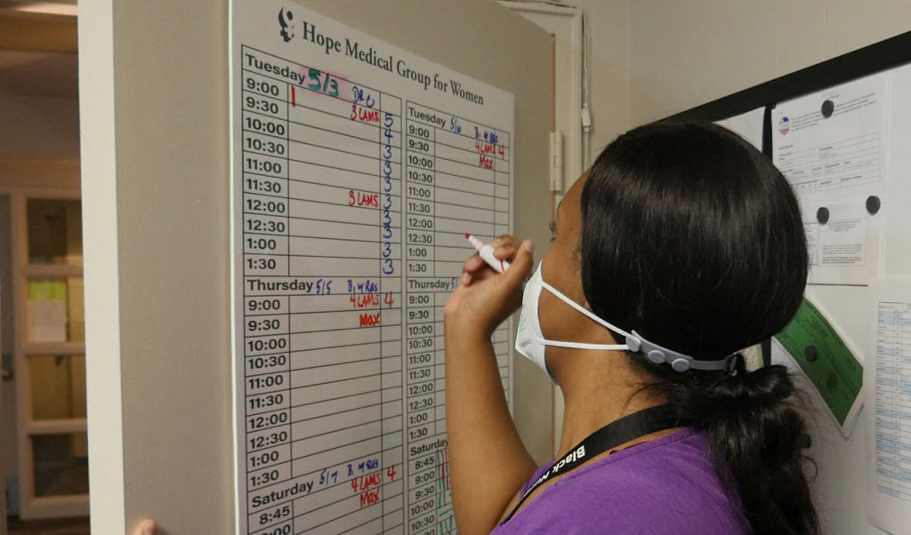 An employee adds codes to a schedule board at the Hope Medical Group for Women in Shreveport, La. on April 19, 2022. (François Picard—AFP/ Getty Images)