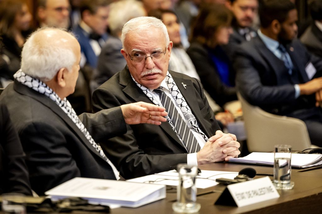 Minister of Foreign Affairs of the Palestinian Authority Riyad al-Maliki (R) listens to a colleague during a hearing at the International Court of Justice (ICJ) on the legal consequences of the Israeli occupation of Palestinian territories.