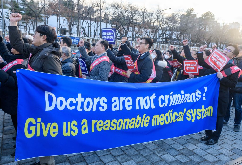 South Korean doctors hold a banner expressing their opinions