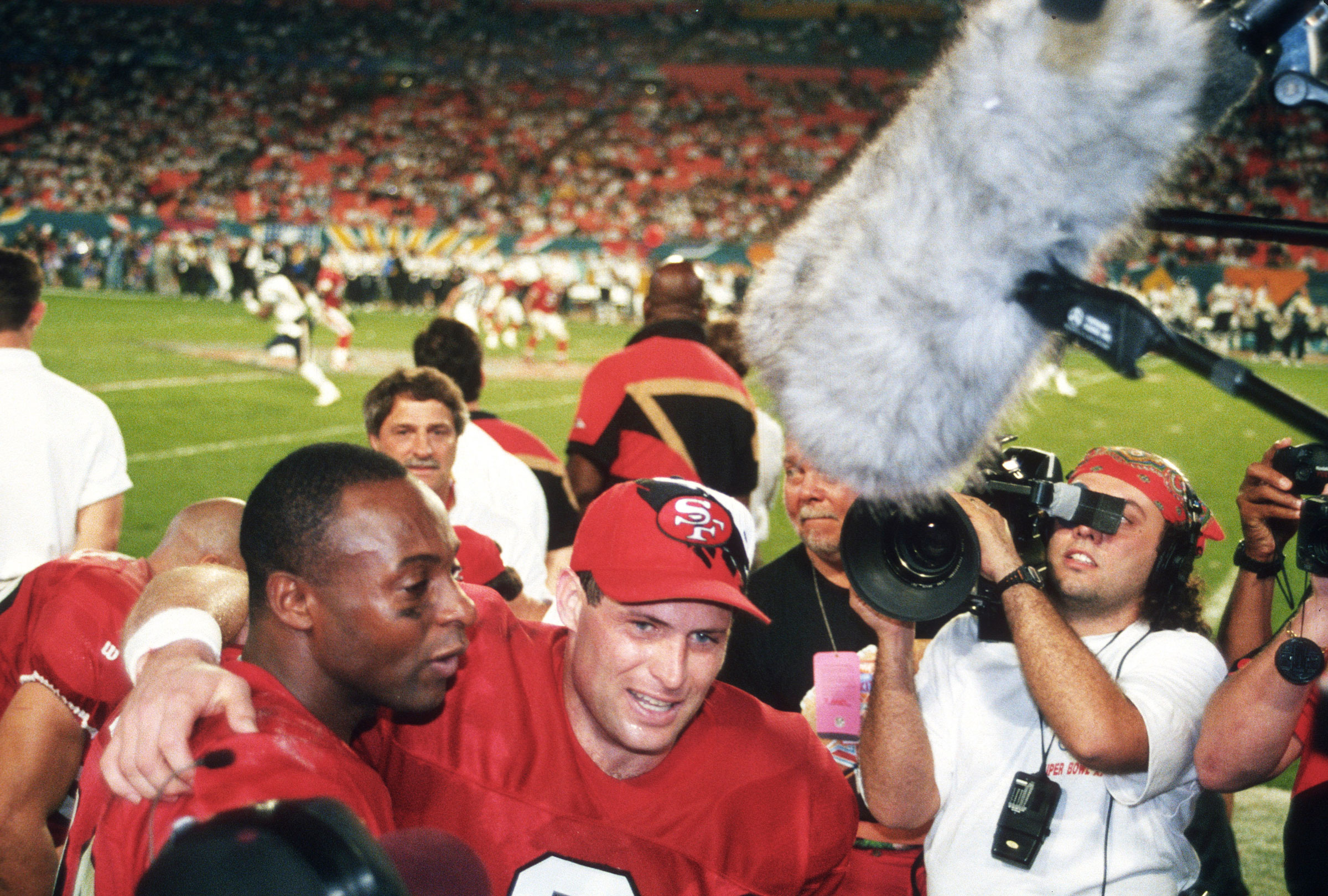 Steve Young celebrates with Jerry Rice on the sidelines while their team leads the San Diego Chargers late in the fourth quarter of Super Bowl XXIX on Jan. 29, 1995.