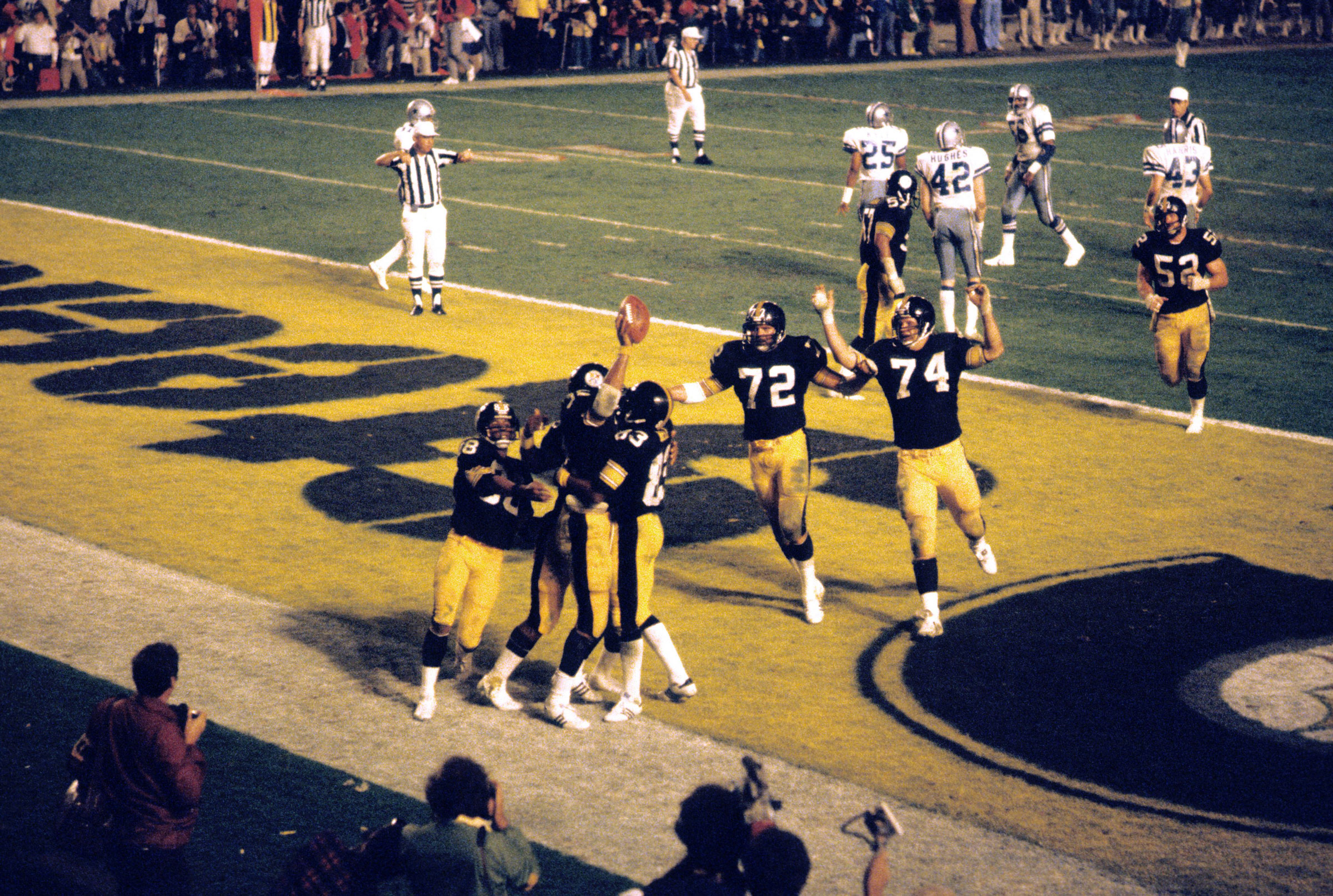 Pittsburgh Steelers Franco Harris victorious with ball and teammates after a touchdown against the Dallas Cowboys in Super Bowl XIII, on Jan. 21, 1979.