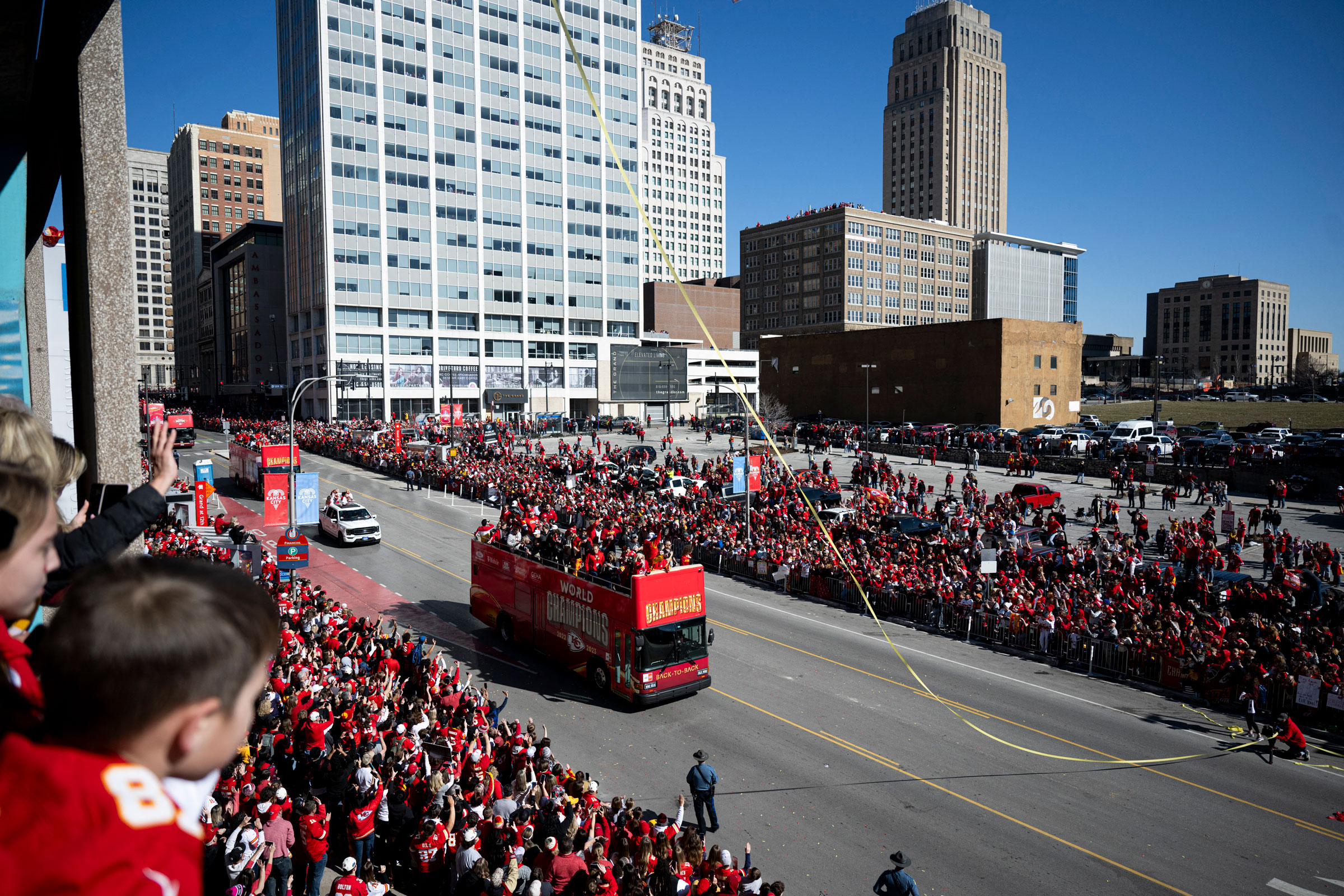 Fans watch as Kansas City Chiefs players celebrate during the Chiefs' Super Bowl LVIII victory parade in Kansas City, Mo., on Feb. 14, 2024.