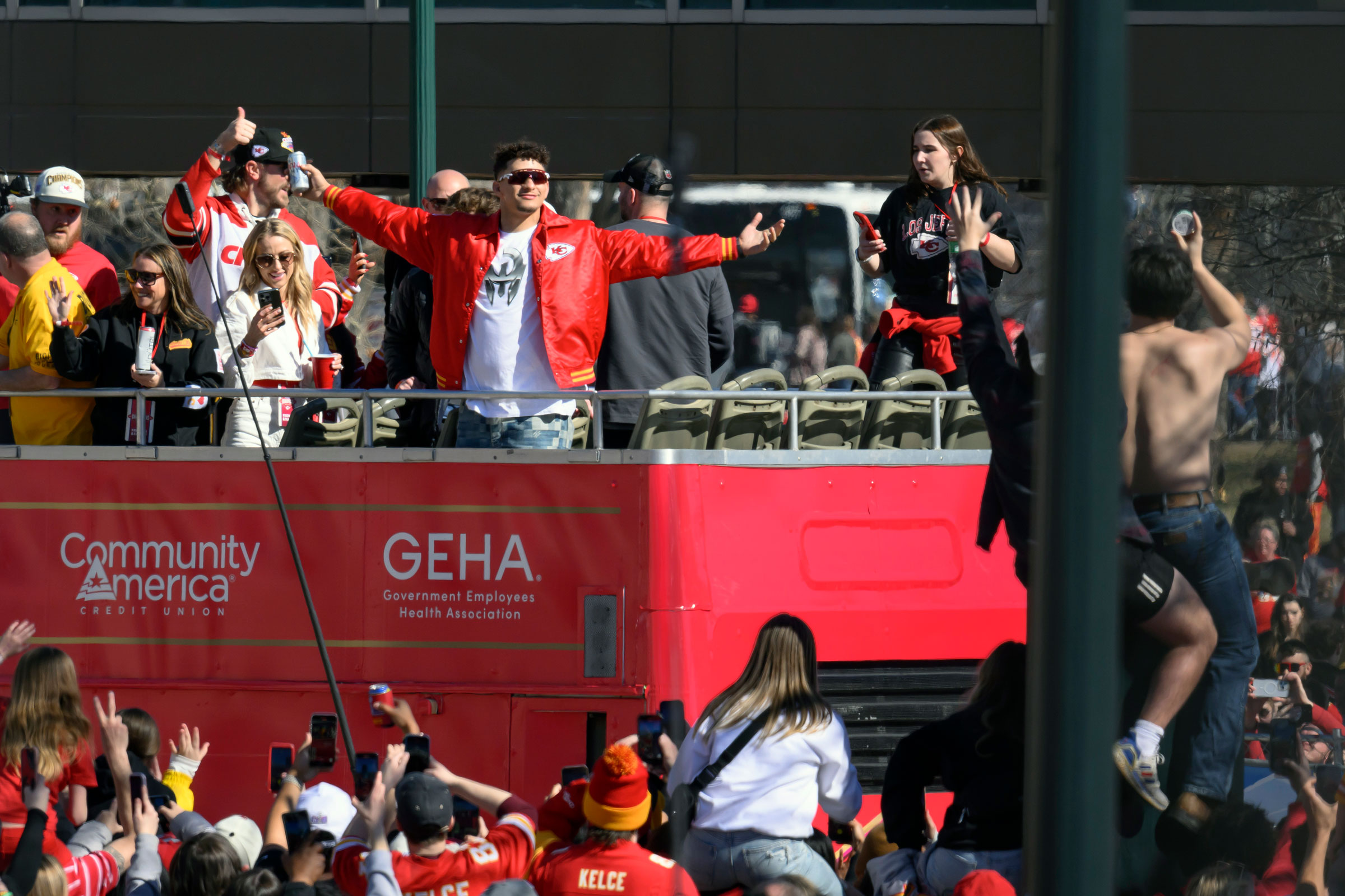 Patrick Mahomes acknowledges the cheers of the crowd as he arrives at the parade.