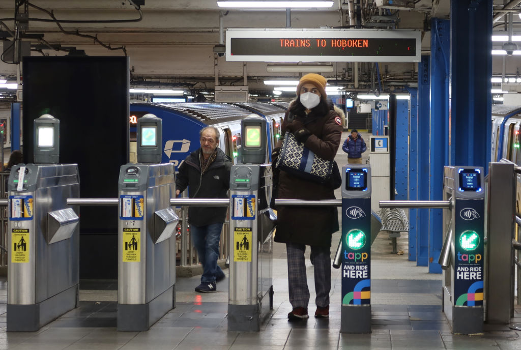 A woman wears a mask in a subway station.