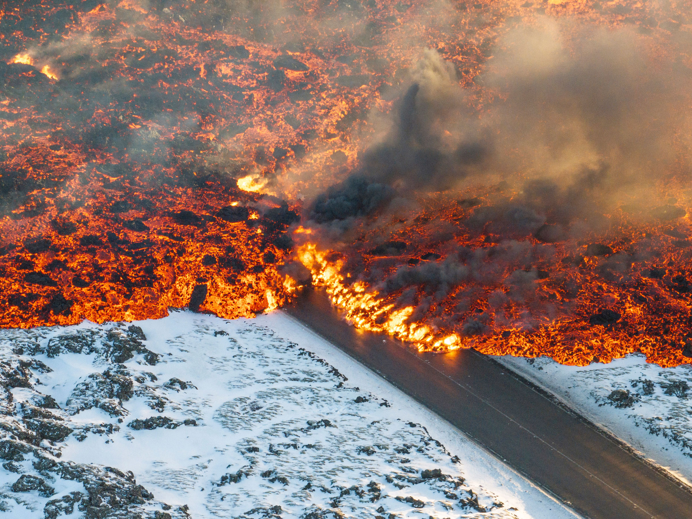 Lava crosses the main road to Grindavík and flows on the road leading to the Blue Lagoon