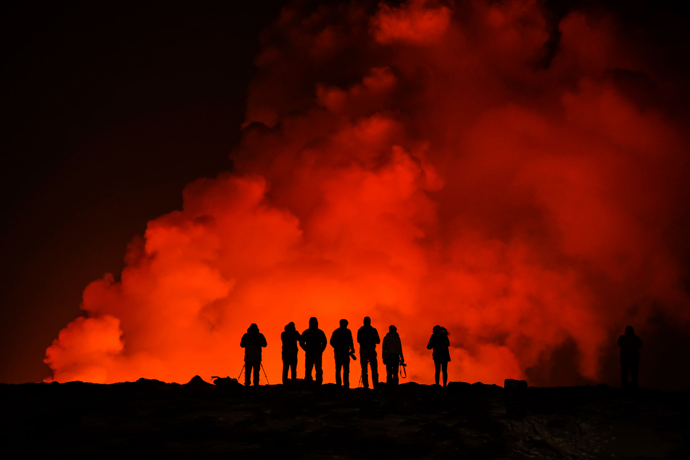 People look at the volcano erupting, north of Grindavík, Iceland, on Feb. 8, 2024.