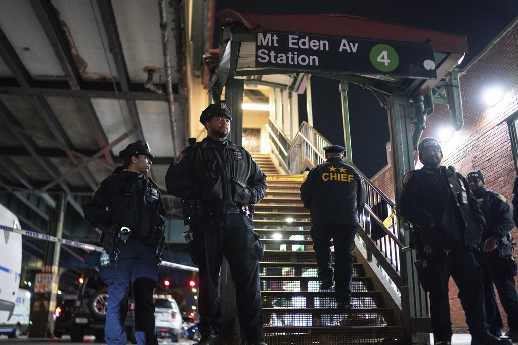 New York City Police officers stand guard following a shooting at the Mount Eden subway station, Monday, Feb. 12, 2024, in the Bronx borough of New York.