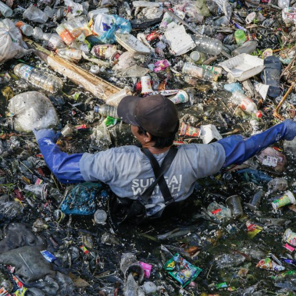 Environmental activists unclogs plastic trash on polluted river before being excavated for sorting and recycling in Denpasar, Bali, Indonesia on Aug. 19, 2023.