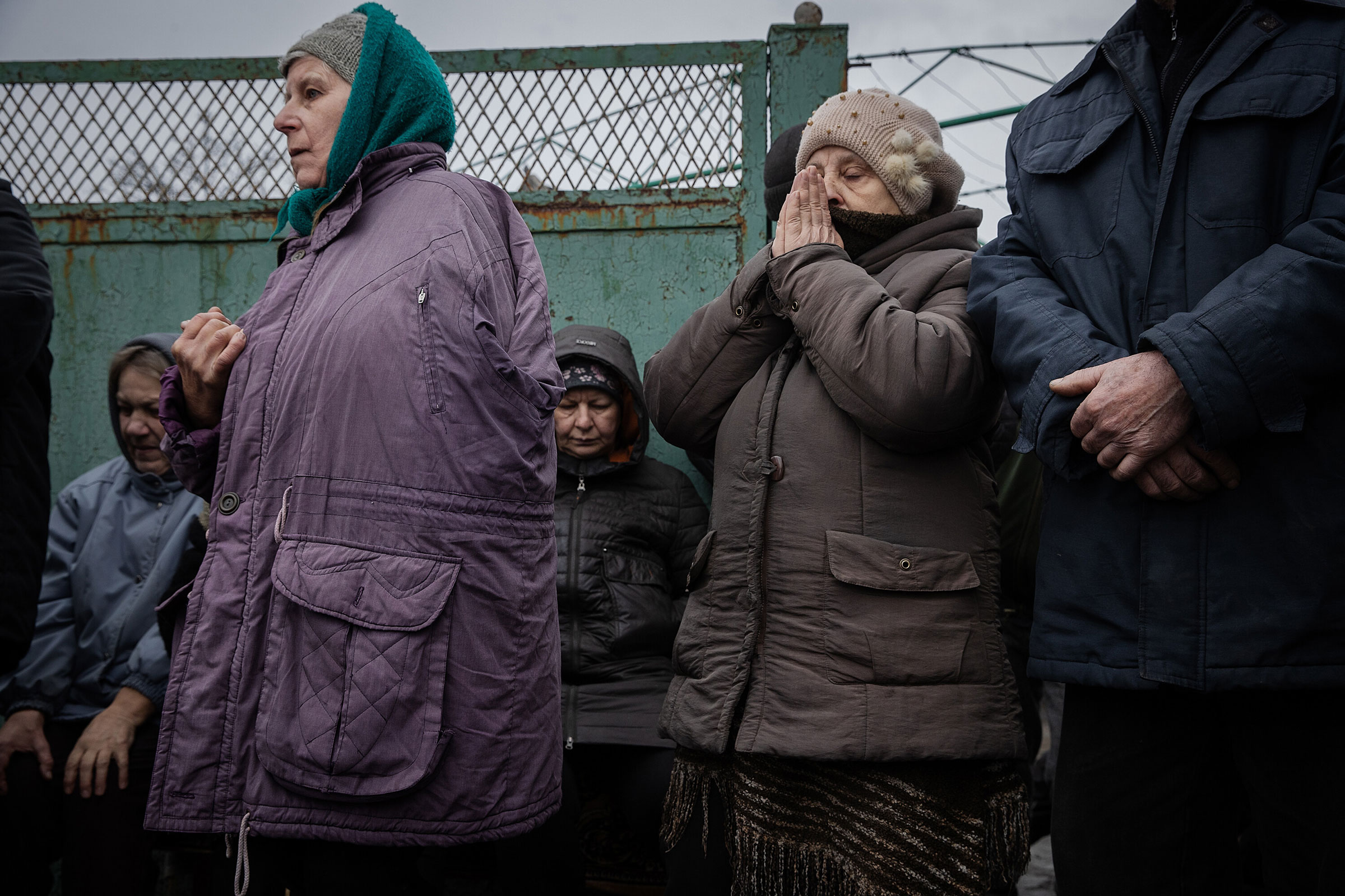 People evacuated from Avdiivka gather to receive food and medicine in Ocheretyne, Ukraine, on Feb. 13, 2024. (Tyler Hicks—The New York Times/Redux)