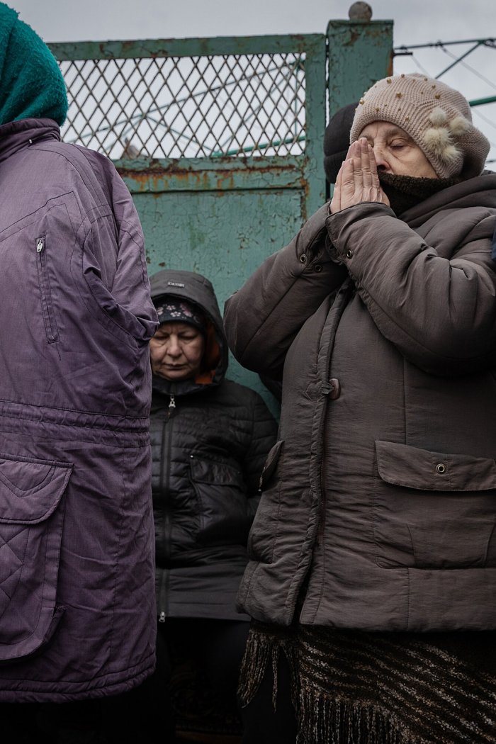 People evacuated from Avdiivka gather to receive food and medicine in Ocheretyne, Ukraine, on Feb. 13, 2024.