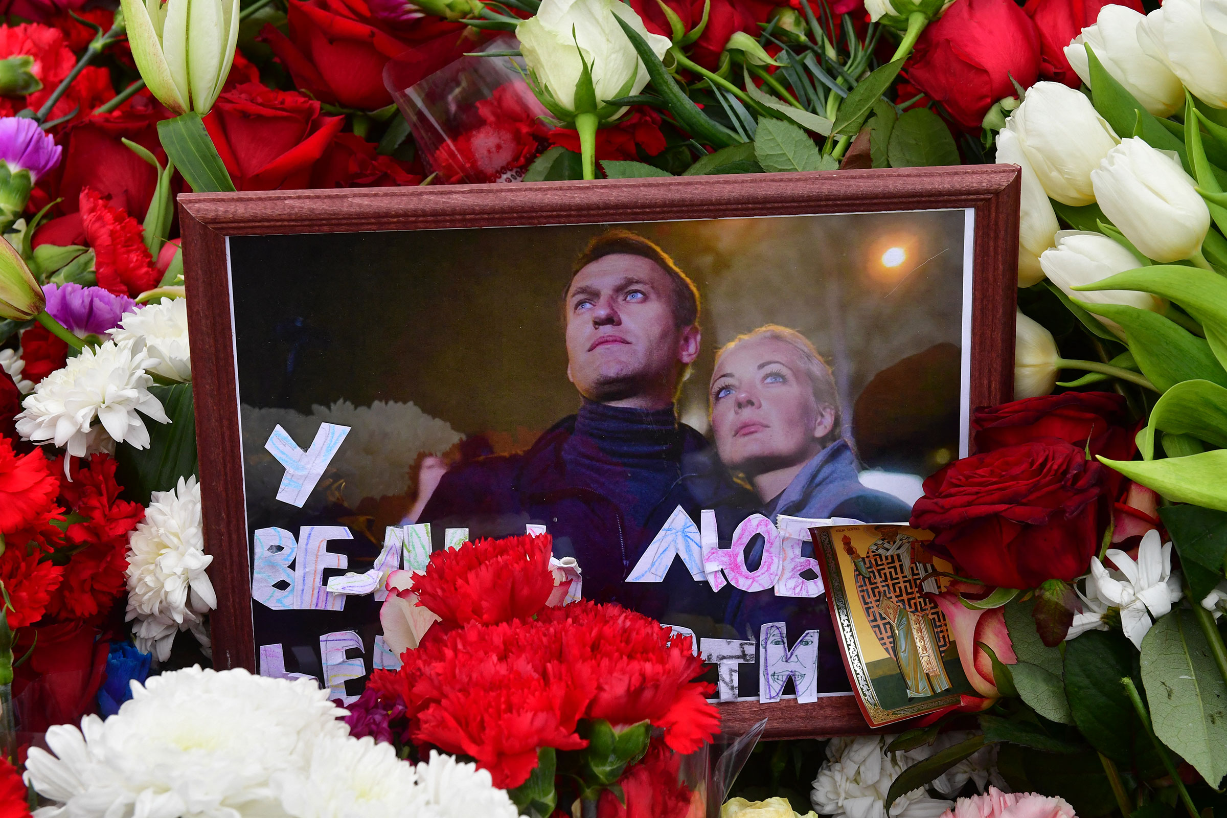 A photograph of Alexei and Yulia Navalny is seen on the grave of Russian opposition leader Alexei Navalny at the Borisovo cemetery in Moscow on March 2, 2024.