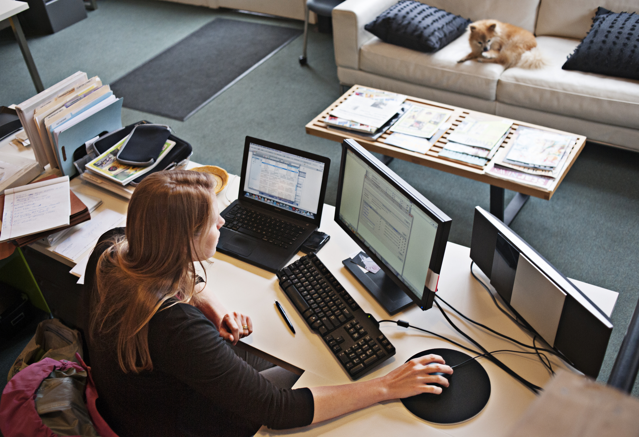 Overview of woman working at office computer