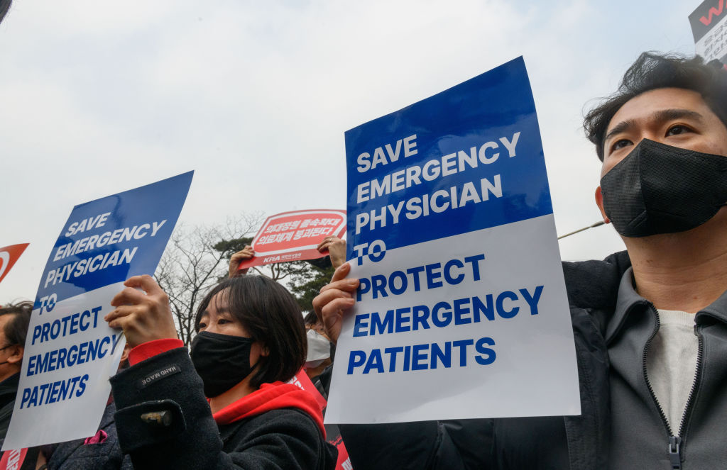 South Korean doctors hold placards during a protest