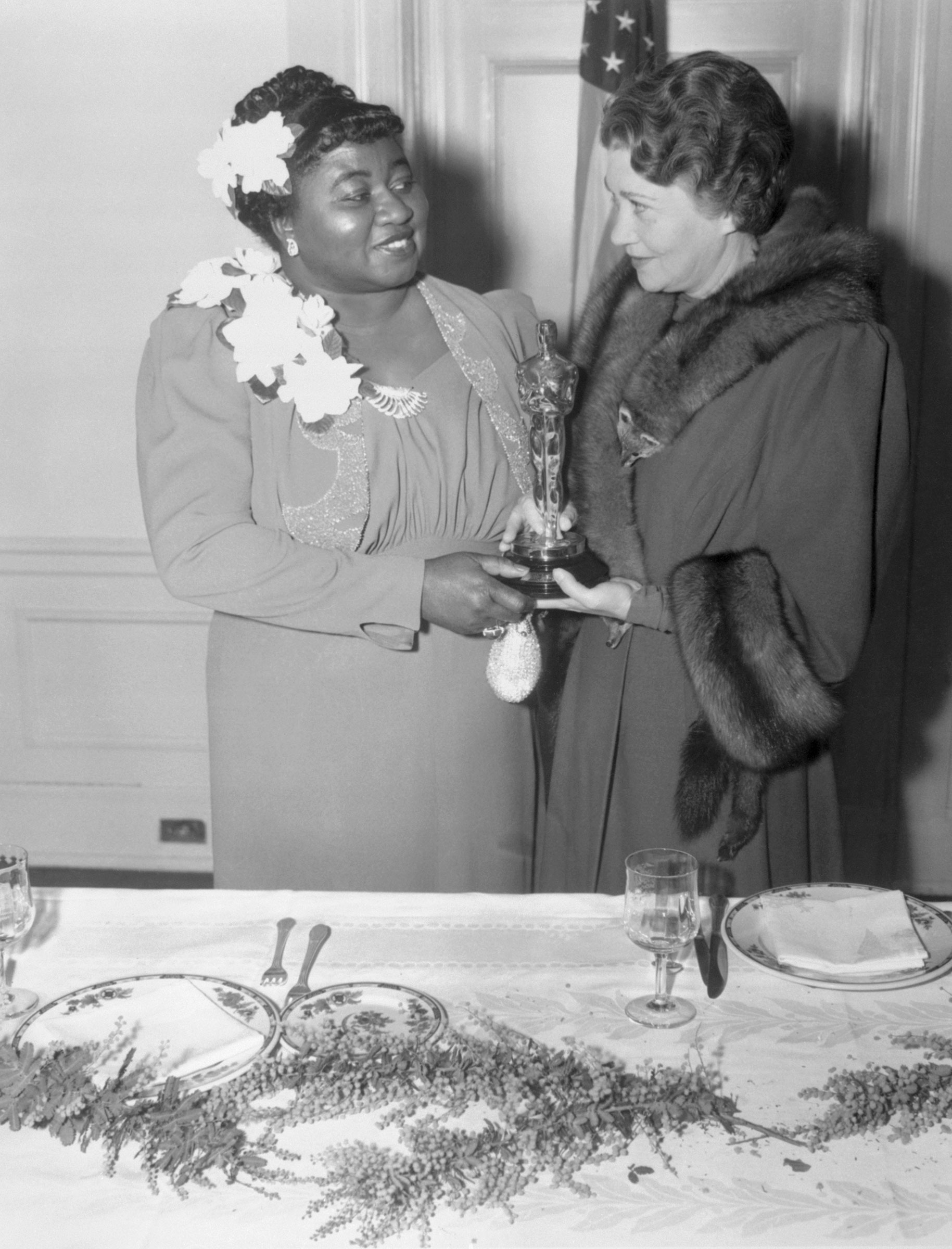 Hattie McDaniel accepts the Oscar, presented to her by Fay Bainter, for her supporting role in Gone With the Wind at the Twelfth Annual Banquet of the Academy of Motion Picture Arts and Sciences on Feb. 29, 1940.