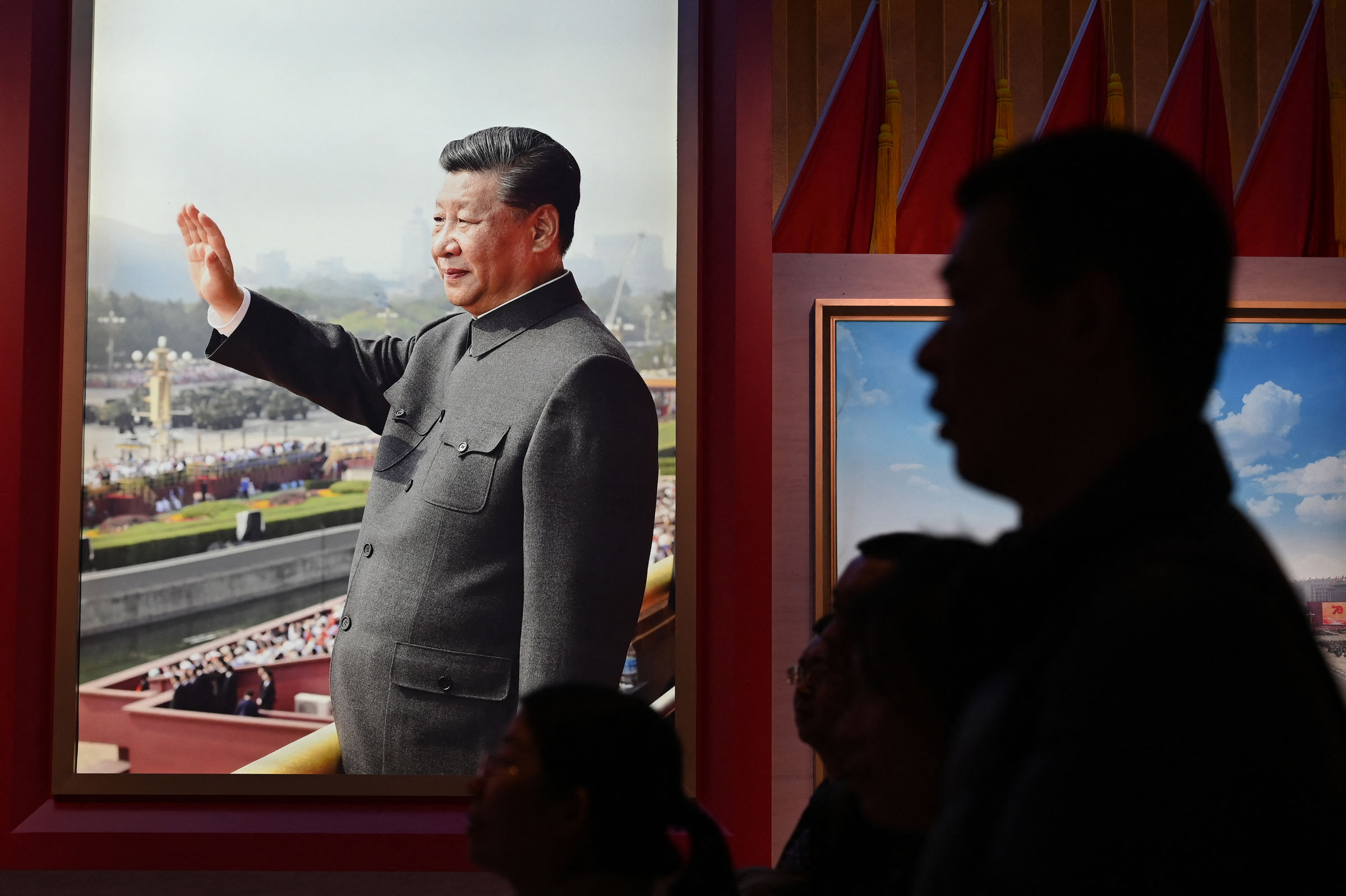 People look at an exhibition featuring Chinese President Xi Jinping at the Military Museum in Beijing on March 3, 2024.