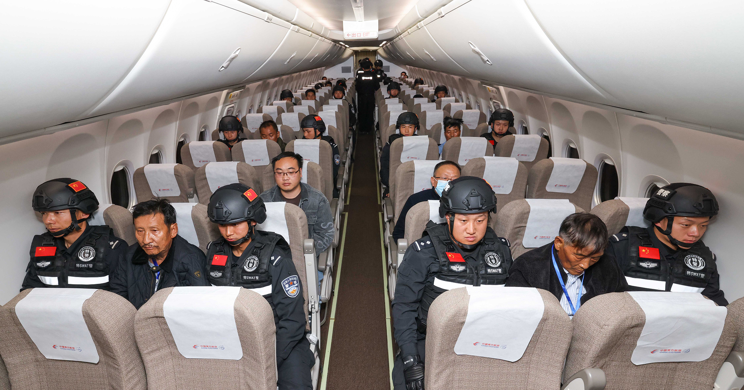 Criminal suspects escorted by Chinese police officers are on a charter flight to China, Jan. 30, 2024.
