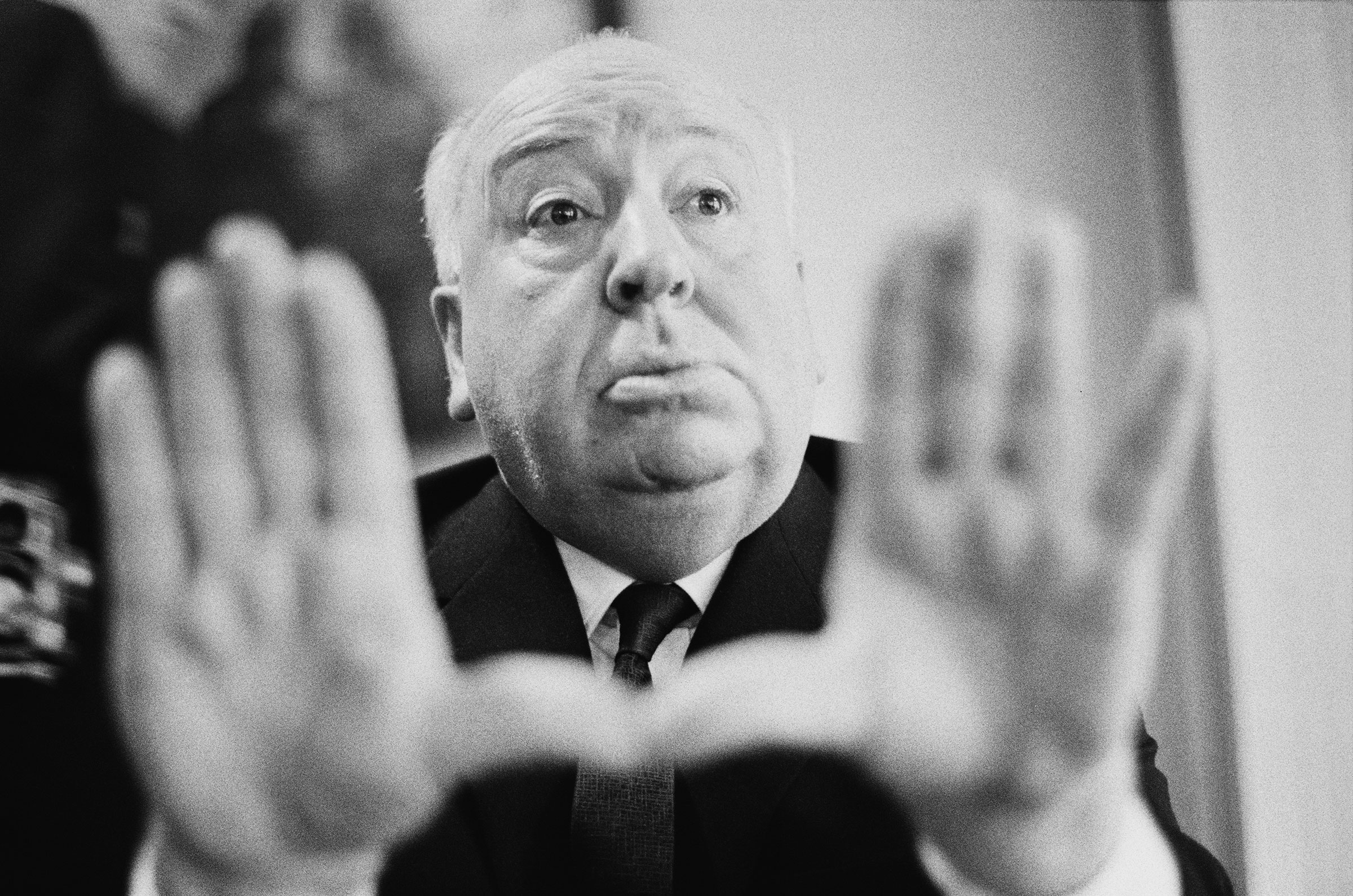 Alfred Hitchcock frames a shot with his hands, 1964