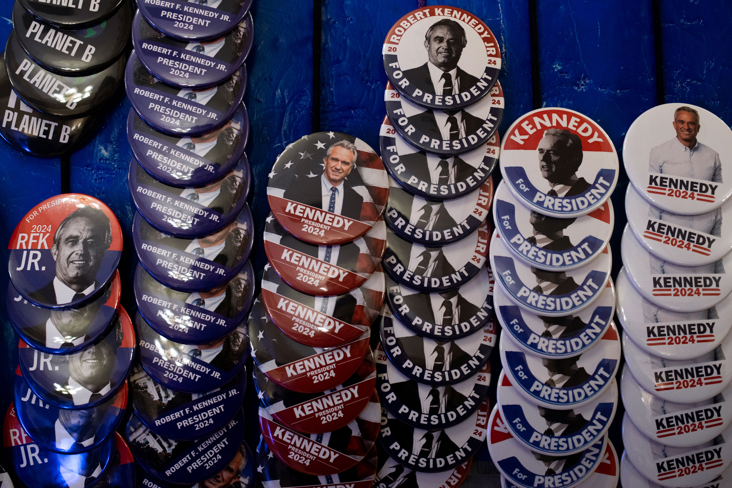 Pins and other merchandise in support of Independent presidential candidate Robert F. Kennedy Jr. on display during a voter rally at St. Cecilia Music Center in Grand Rapids, Mich., on Feb. 10, 2024.
