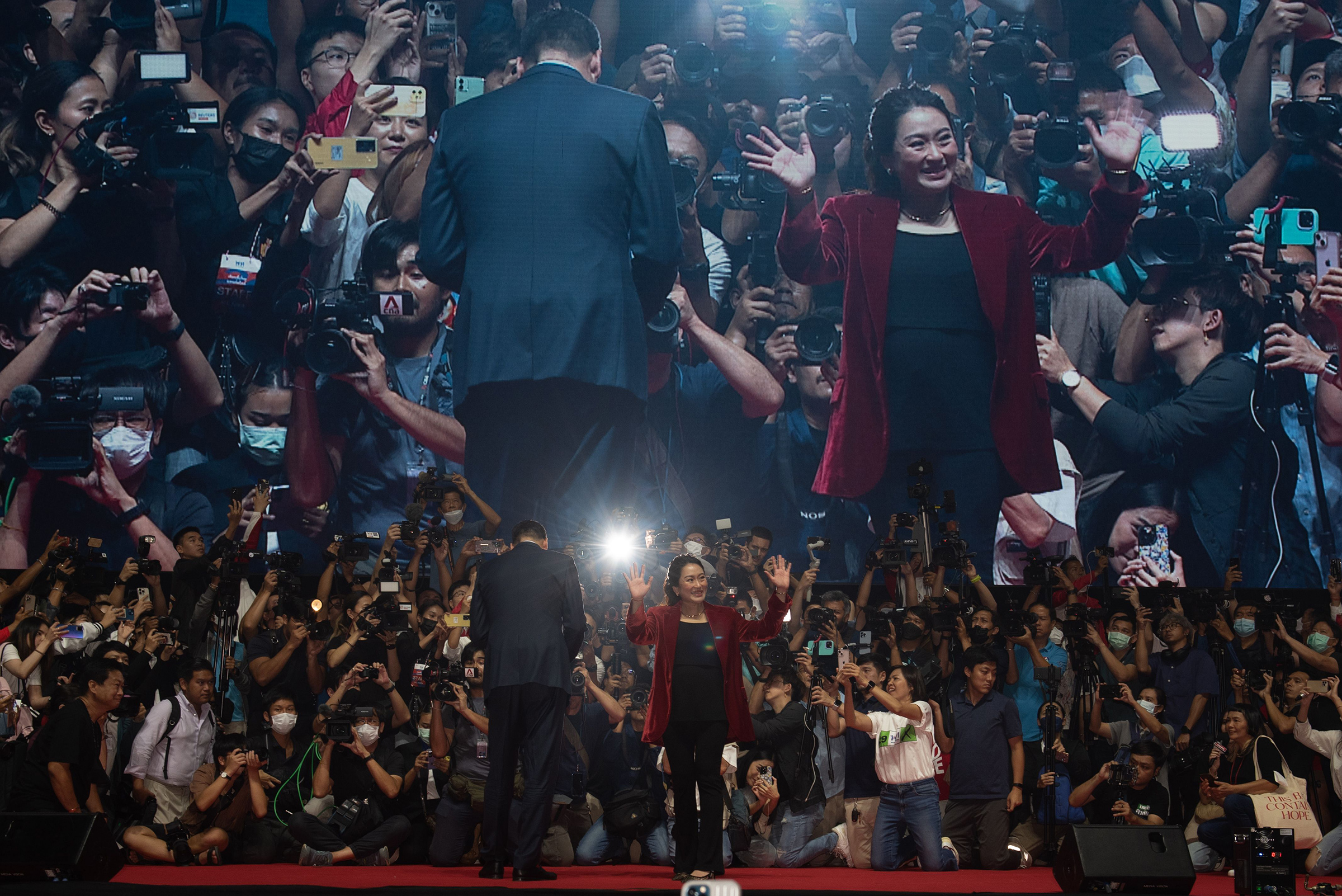Pheu Thai party candidates Srettha Thavisin, left, and Paethongtarn Shinawatra, right, at the final campaign event ahead of the upcoming general election, on May 12, 2023.