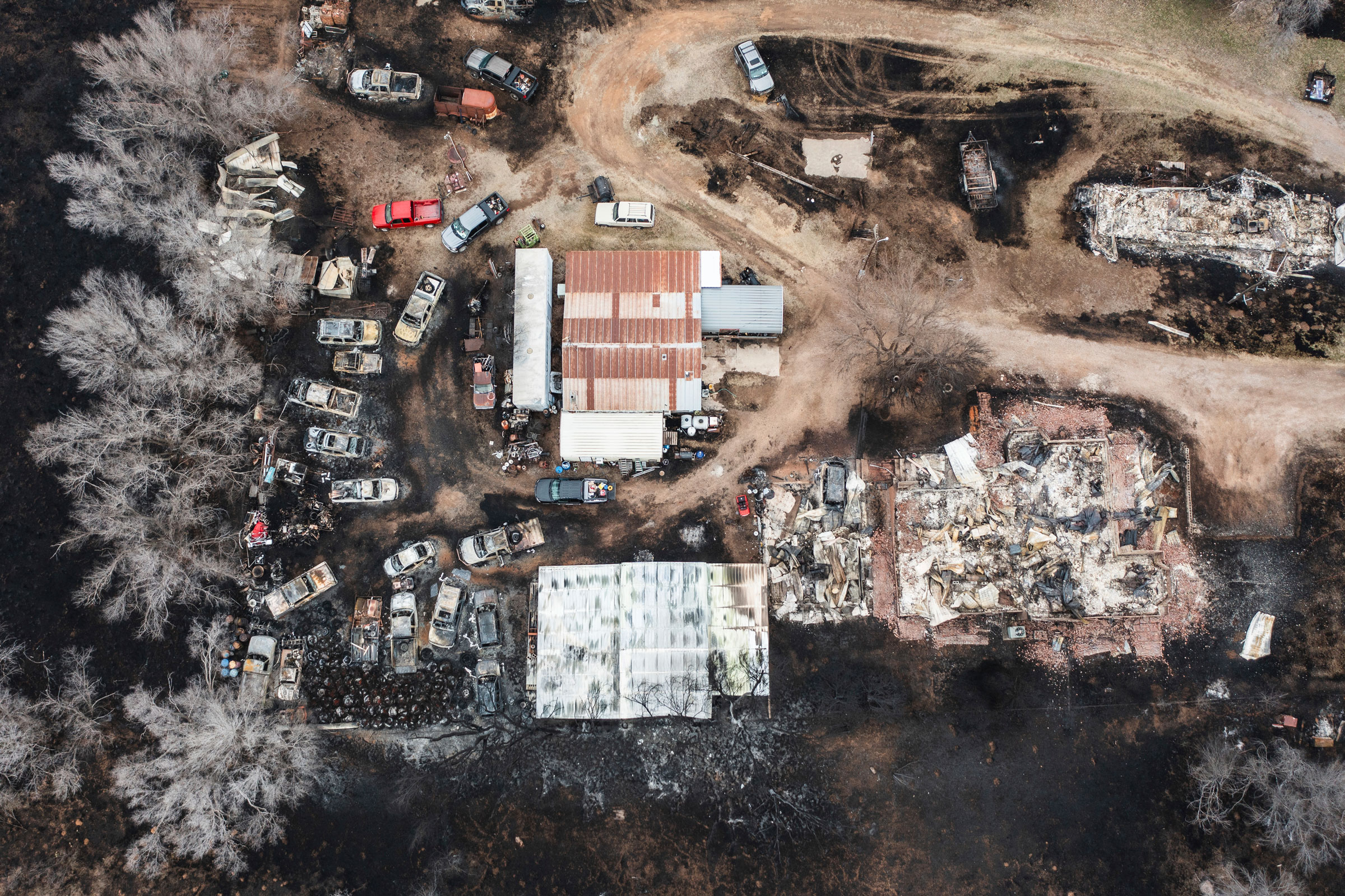 Multiple vehicles and multiple residences are seen destroyed by the Smokehouse Creek Fire in Canadian, Texas, on Feb. 29, 2024.