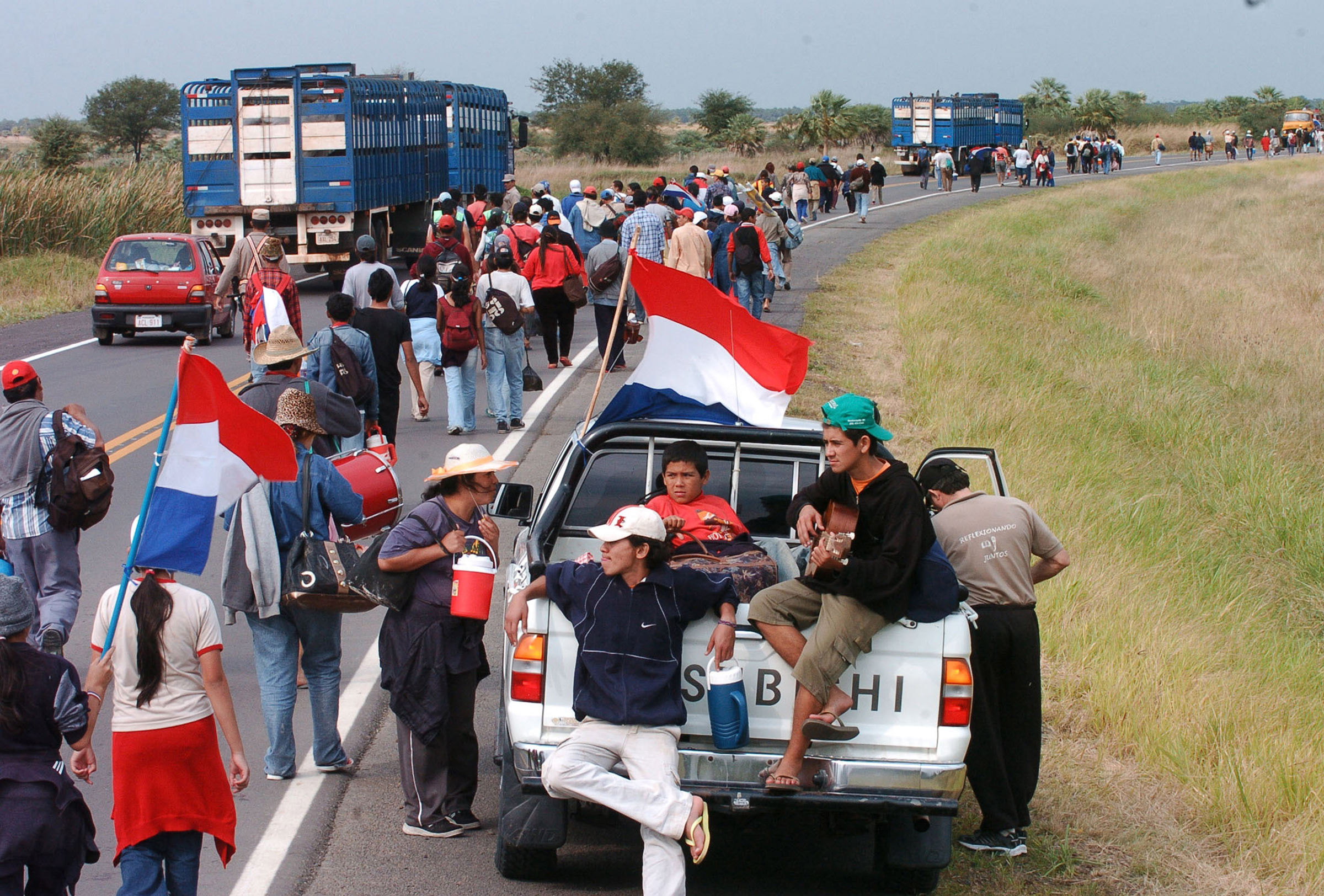 Paraguayans from the town of Puerto Casado take part in a 148km (91 miles) march from their homes towards Asuncion, the capital, to pressure the government to turn some of the land, acquired in their region by the Unification Church of Reverend Moon, over to them for subsistence farming, in Tacuara, Paraguay, on July 16, 2005.