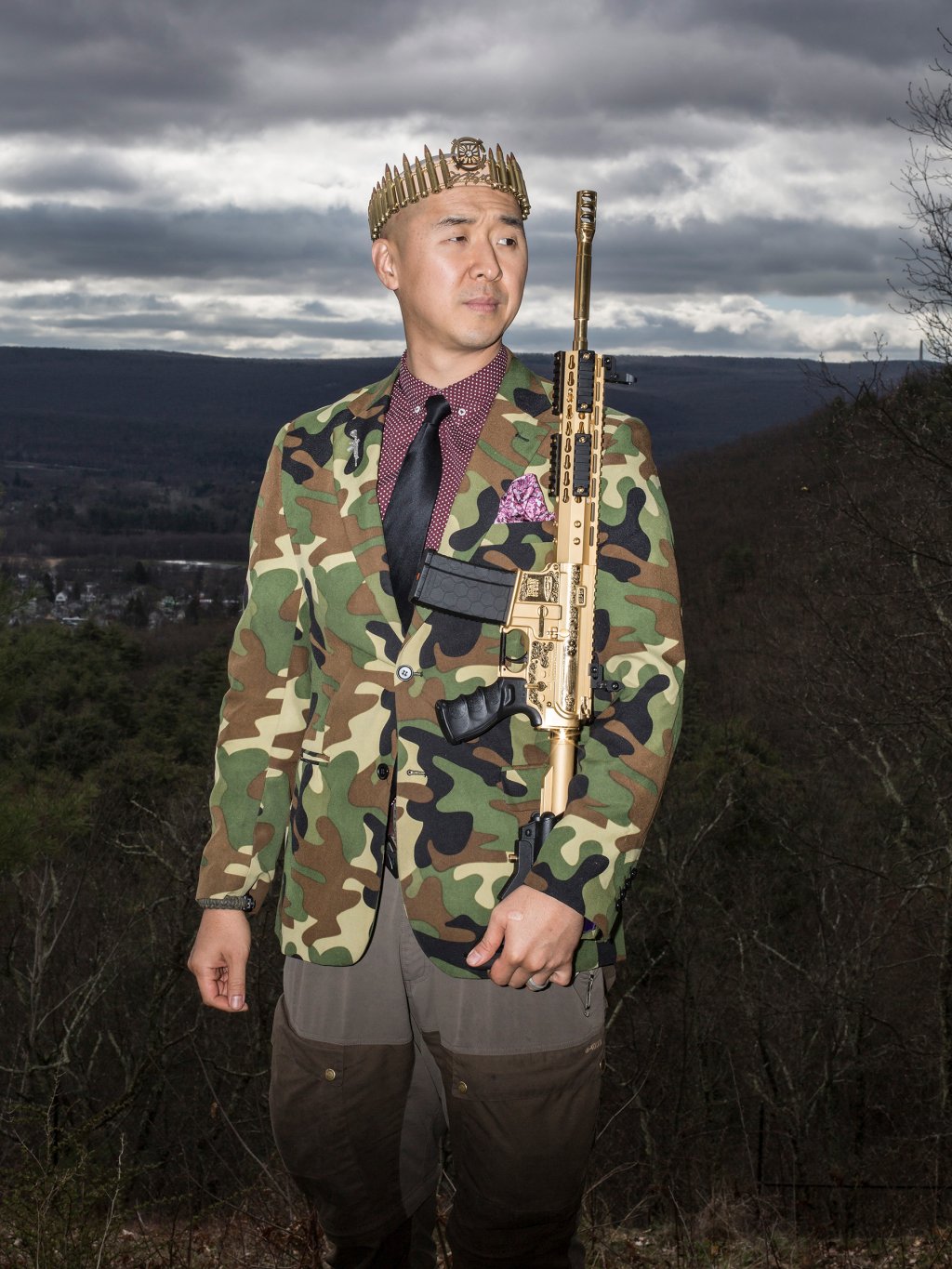 Reverend Hyung Jin "Sean" Moon poses for a portrait with his gold AR-15 "rod of iron" at Moon's home in Matamoras, Penn., on April 26, 2018.