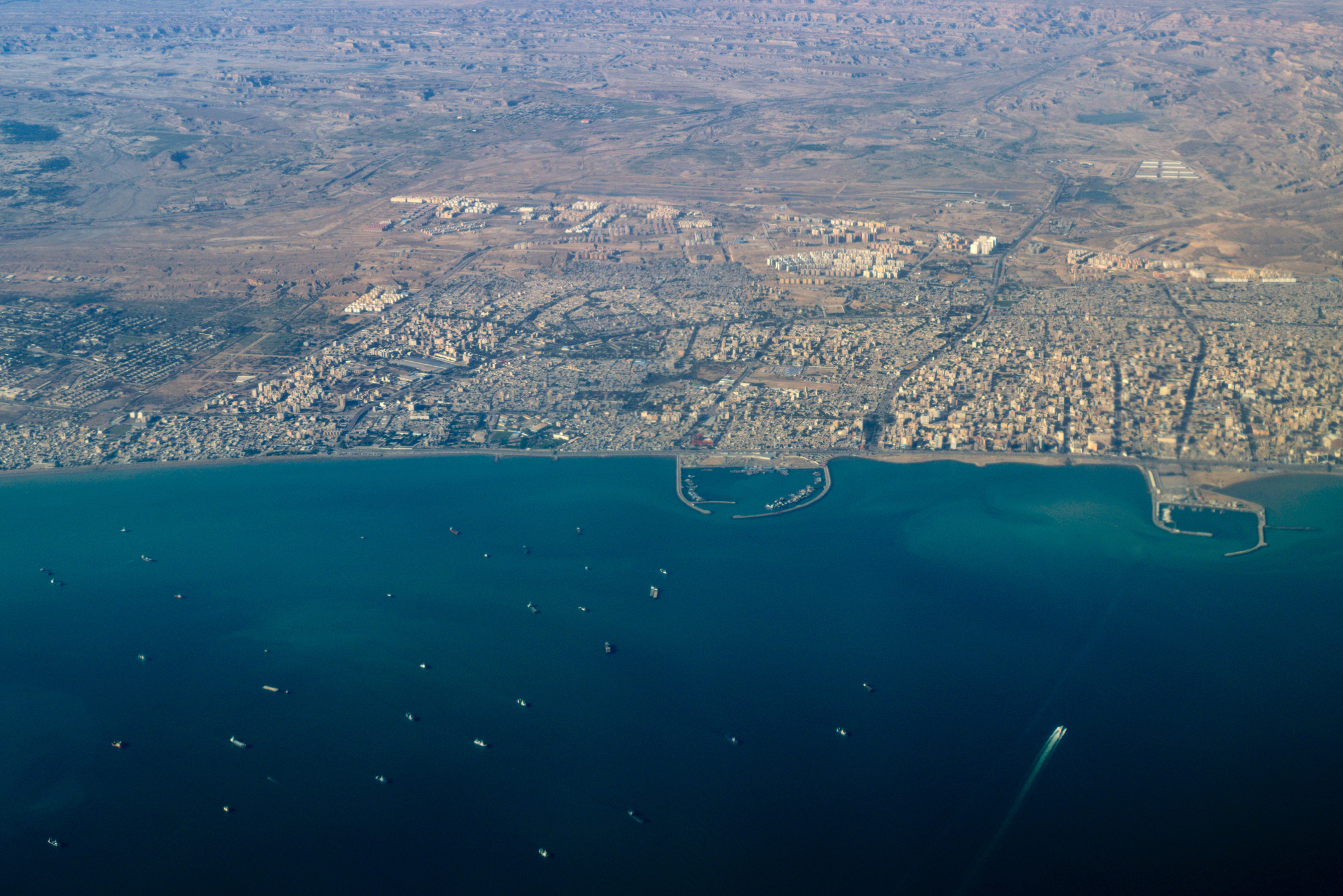 Aerial view of Bandar Abbas major Iranian Persian Gulf port city with several harbors and ship traffic, Strait of Hormuz, Iran
