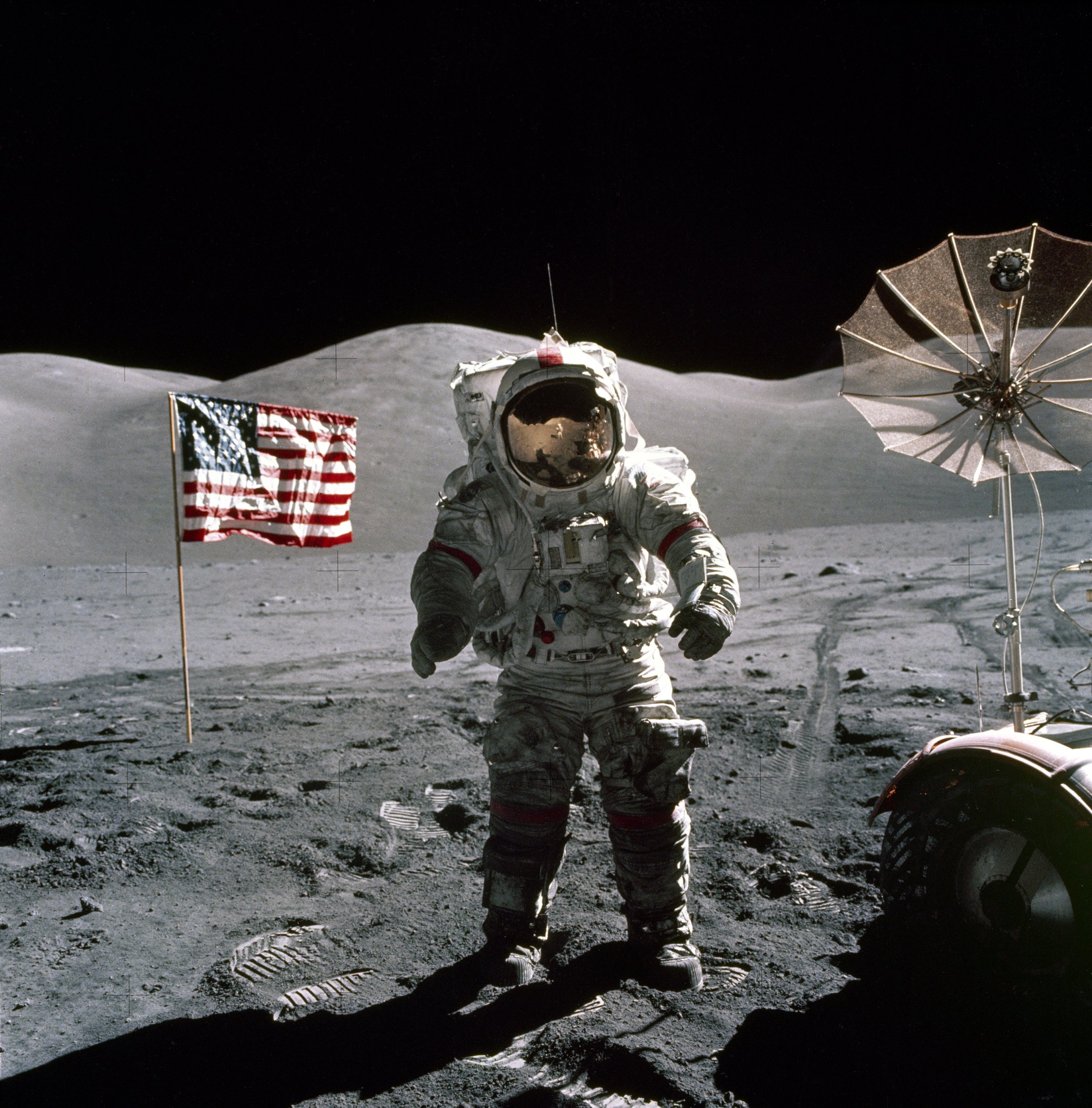 This is an Apollo 17 Astronaut standing upon the lunar surface with the United States flag in the background