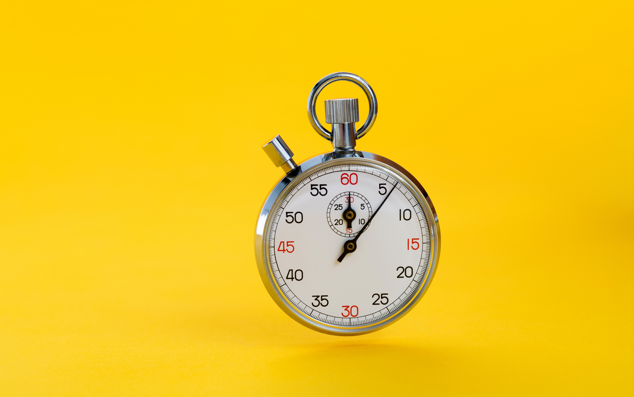 A stopwatch on yellow background
