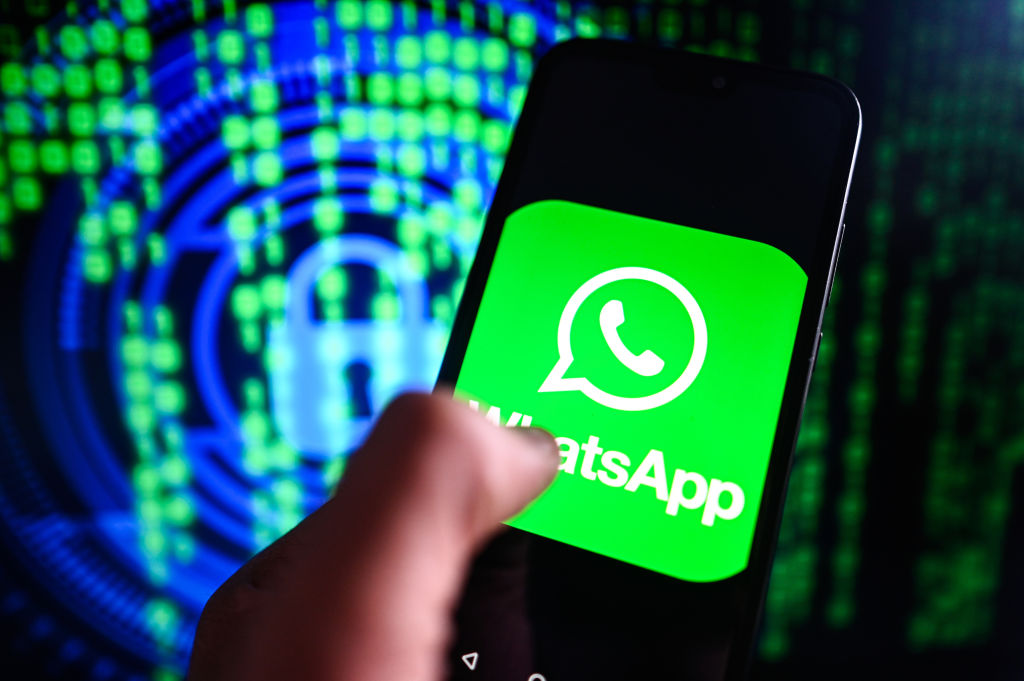 In this photo illustration a WhatsApp logo is displayed on a