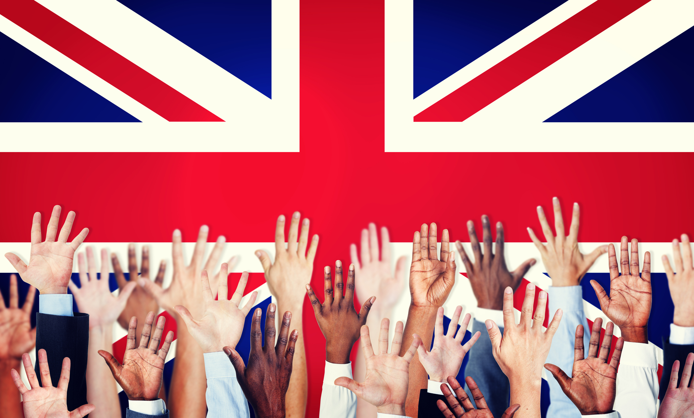 Group of Multi-Ethnic Arms Raised with Flag of United Kingdom