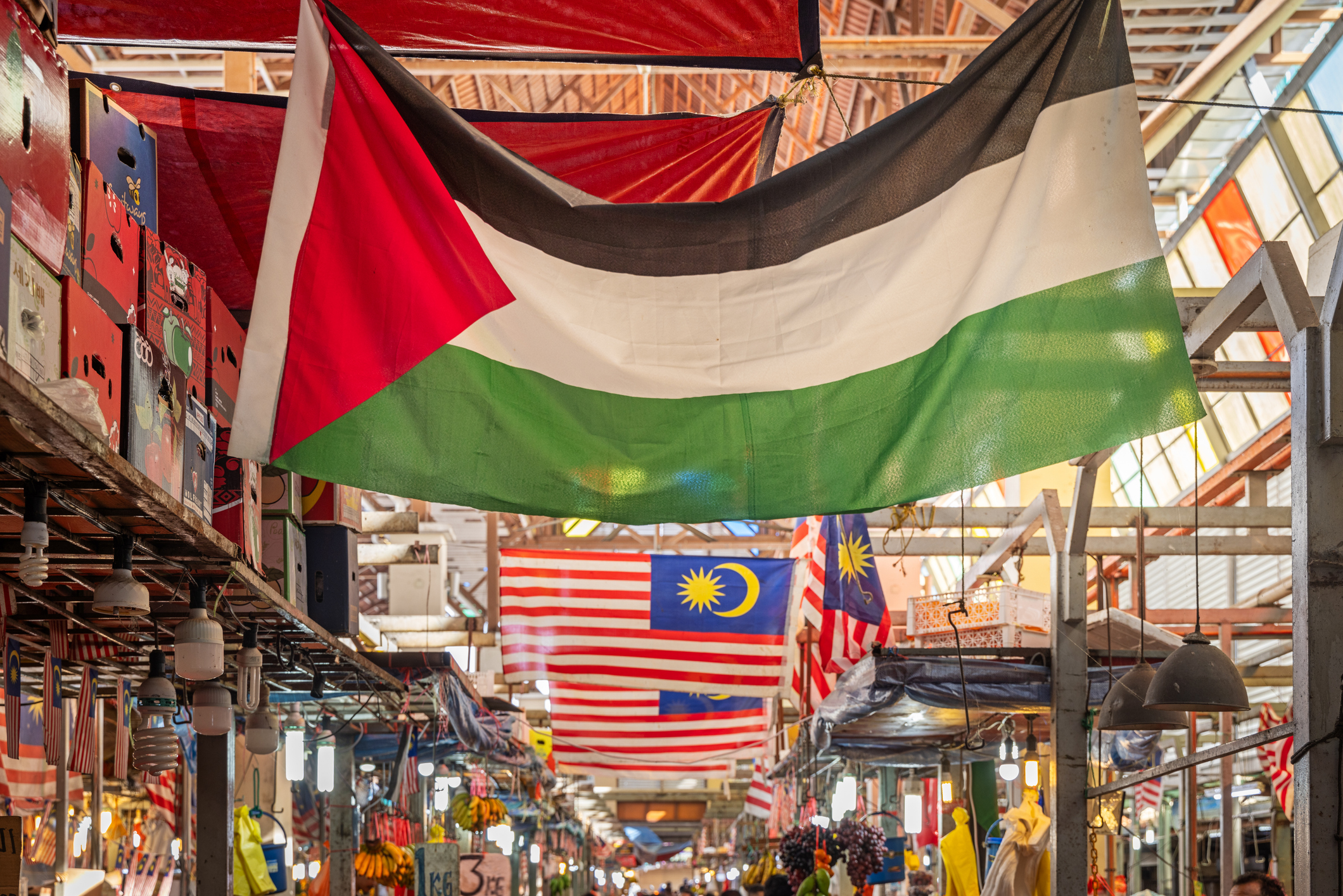 Palestinian flag under the roof in a market hall