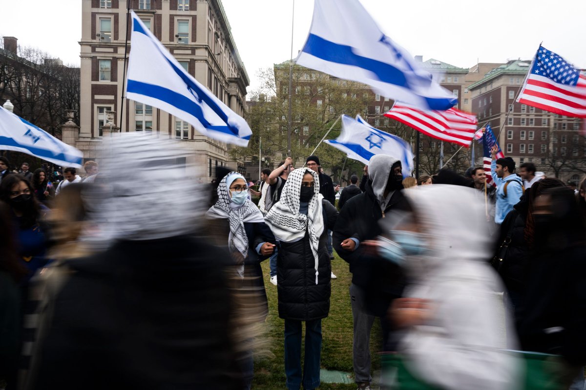 Students line up in front of pro-Israel students to protect a large pro-Palestine picket line at Columbia University on April 18, 2024.