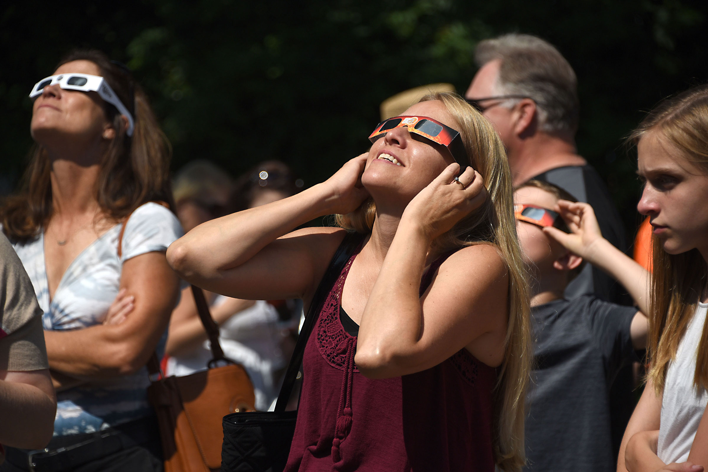 People use special eclipse glasses to watch the solar eclipse, on Aug. 21, 2017 in Schenectady, N.Y.