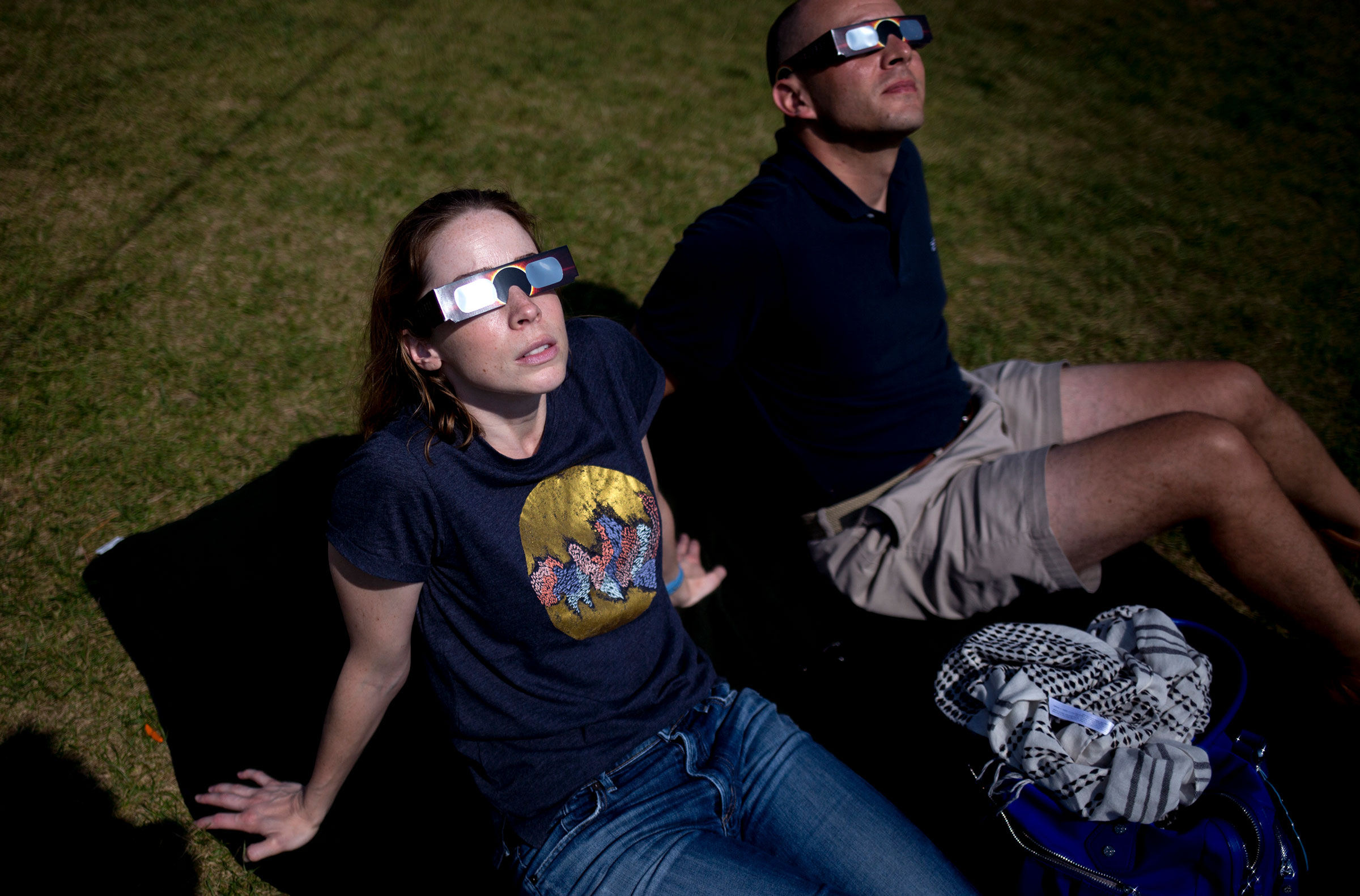 People watch the partial solar eclipse at in Freeport, Maine.