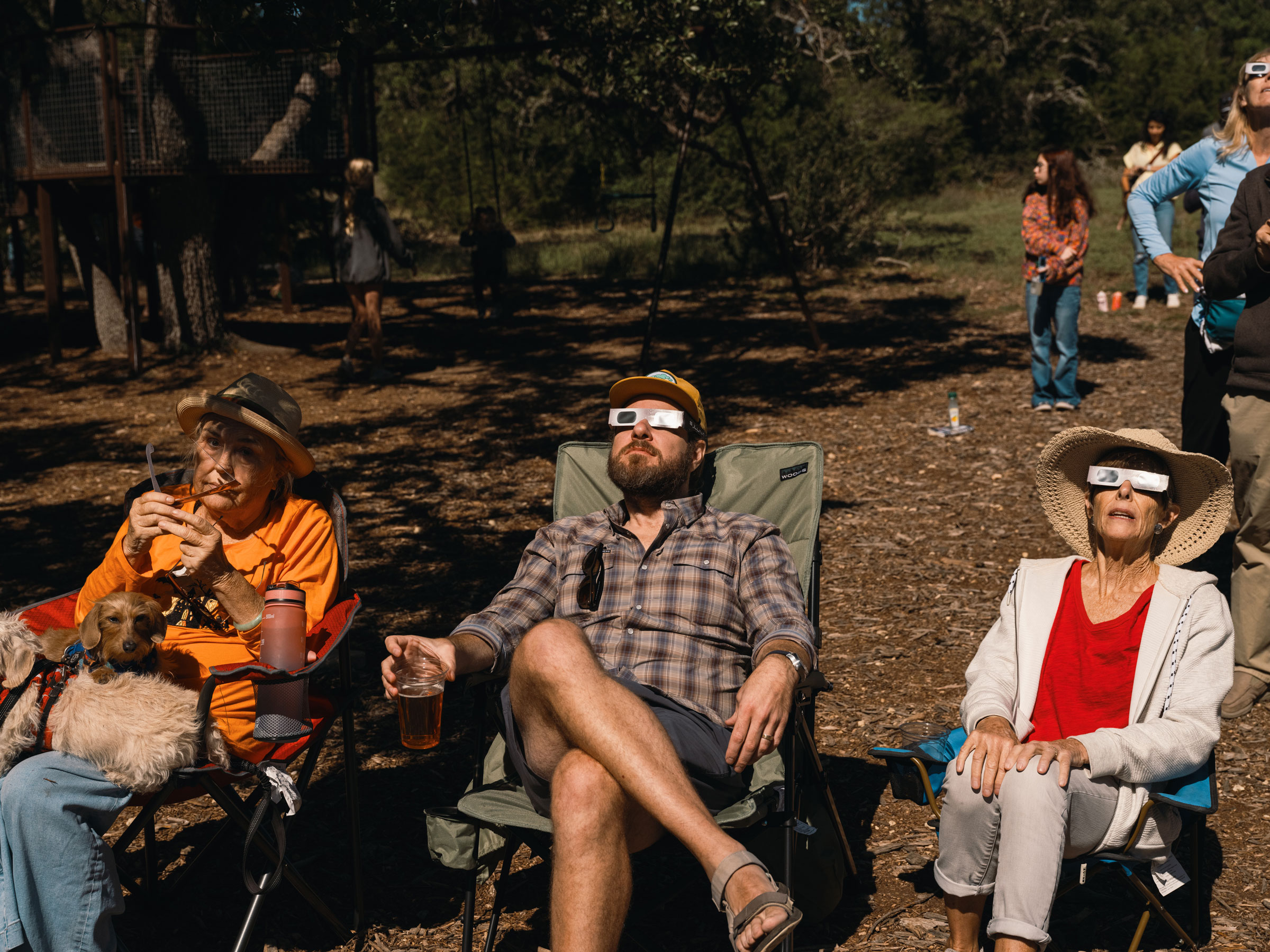 Spectators wear solar viewing glasses during a solar eclipse in Driftwood, Texas, on Oct. 14, 2023.