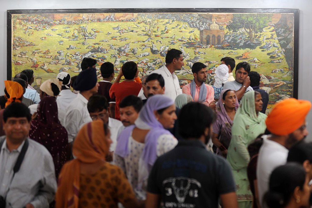 Indian visitors in Amritsar in 2011 look at a painting depicting the Jallianwala Bagh massacre
