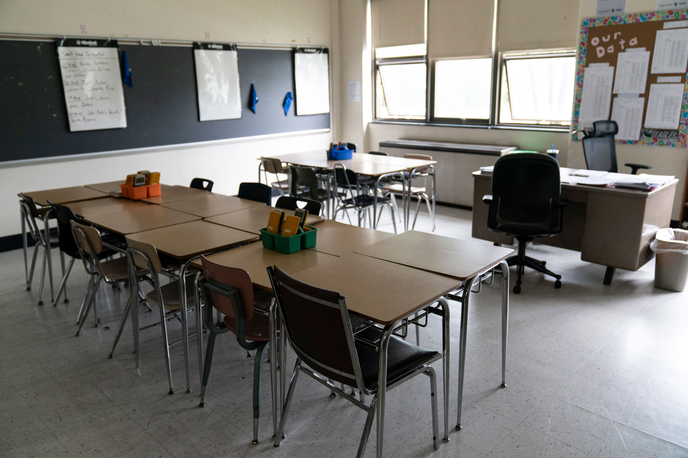 Desks fill a classroom in a high school