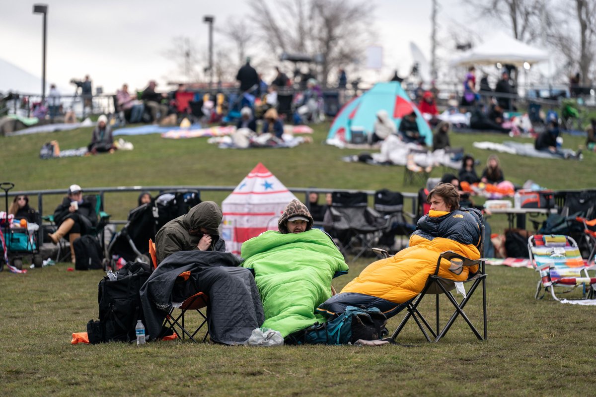 People wrap up warm as they wait for the solar eclipse in Niagara Falls, N.Y., on April 8, 2024.