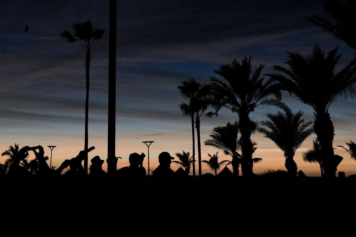 People watch a total solar eclipse as the sky goes dark in Mazatlan, Mexico.