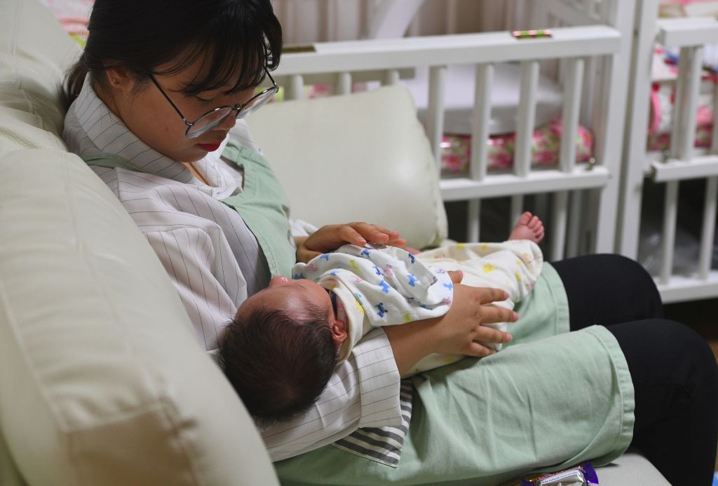 A social worker cares for a baby at the Jusarang Community Church in southern Seoul on May 24, 2017.