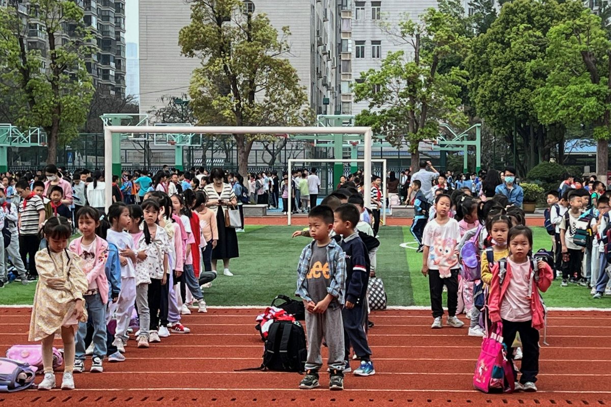 Students evacuate to the playground at a school in Xiamen, in eastern China’s Fujian province
