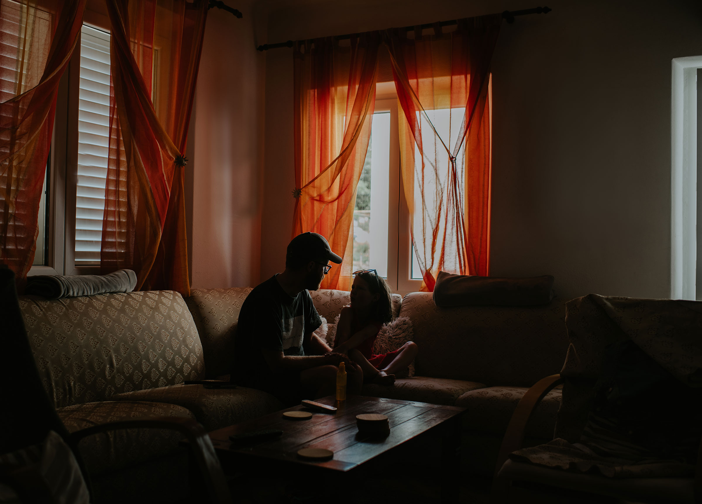 A father and daughter share a quiet moment in a home environment