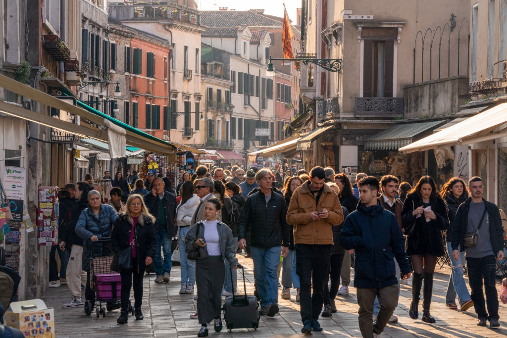 Tourists line a street in Venice, Italy, on Saturday, March 16, 2024.