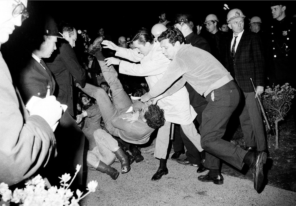 New York City plainclothes policemen drop a student protester on the ground after he and others holding a sit-in at a Columbia University building were removed, April 30, 1968.