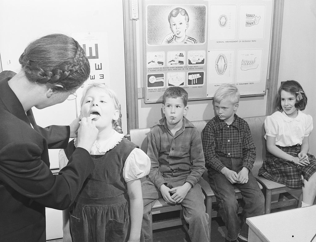 Nurse Checking Nursery Schooler's Teeth