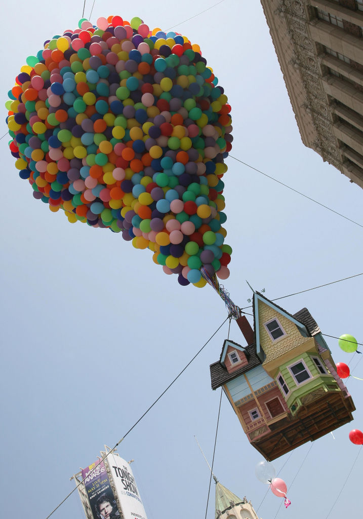 Balloons hold up a house at the premiere